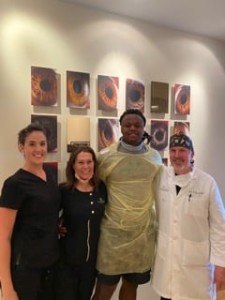 Deonte Johnson with Dr. Haines and team